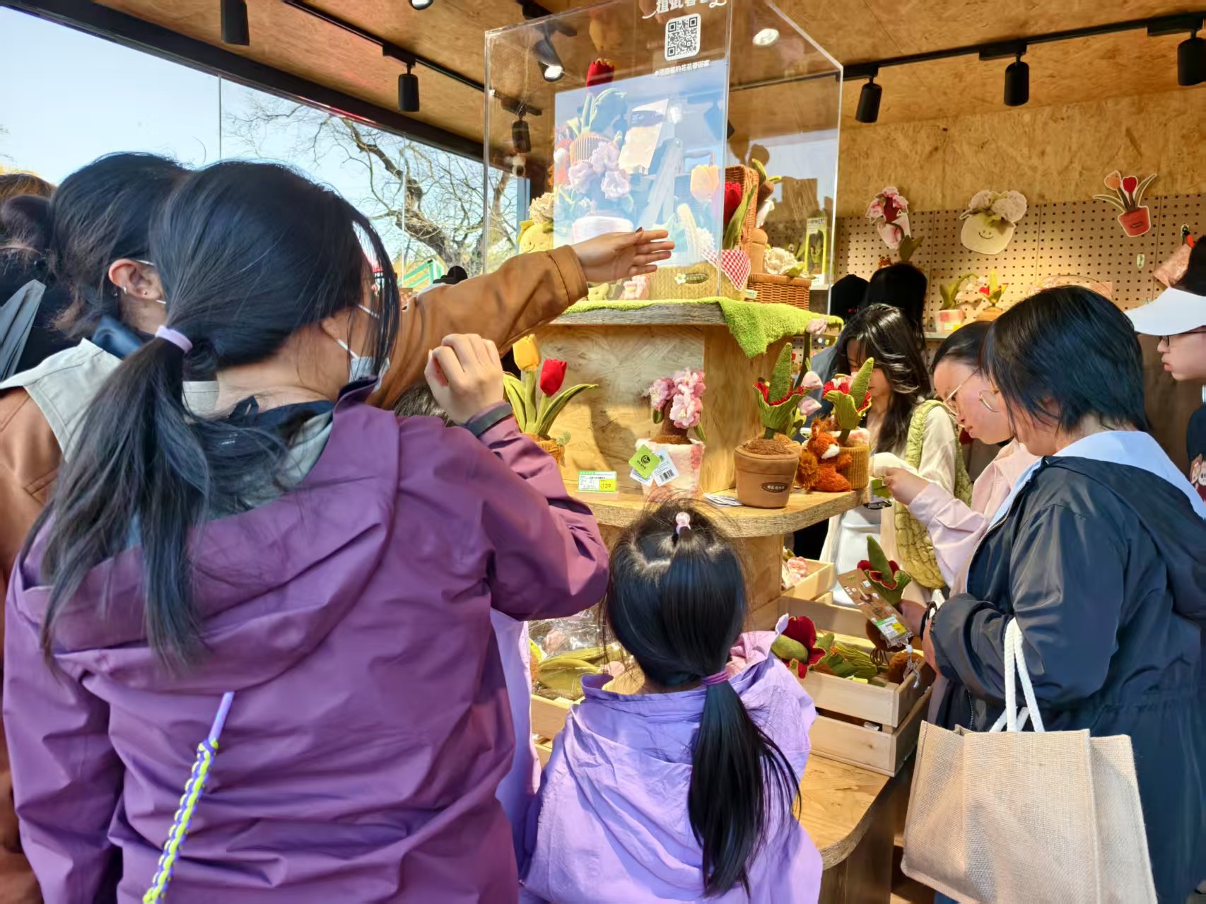 游客在国家植物园购买植物毛绒玩具。人民网记者 